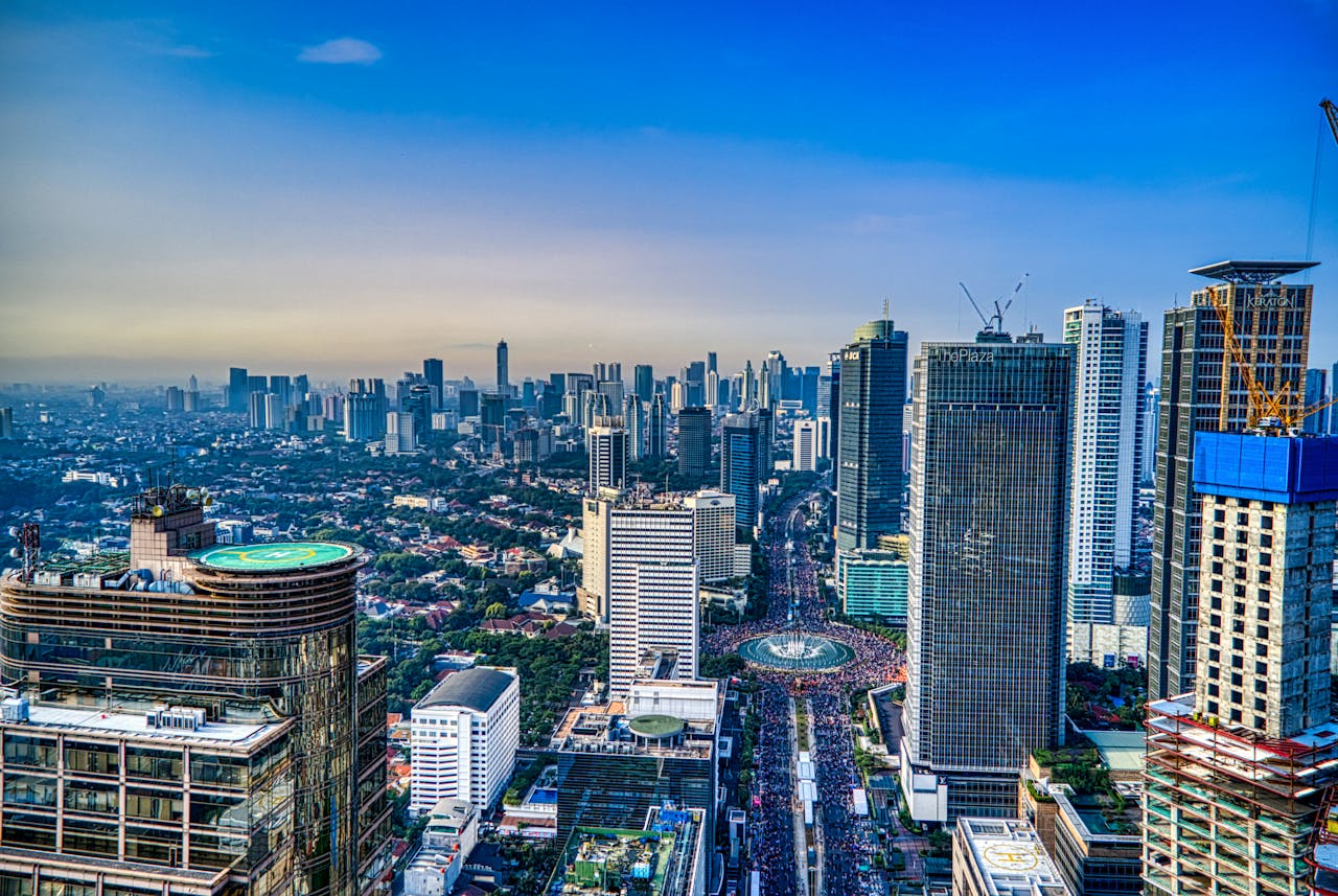 A breathtaking aerial view of Jakarta's urban skyline during the day, showcasing skyscrapers and city life.