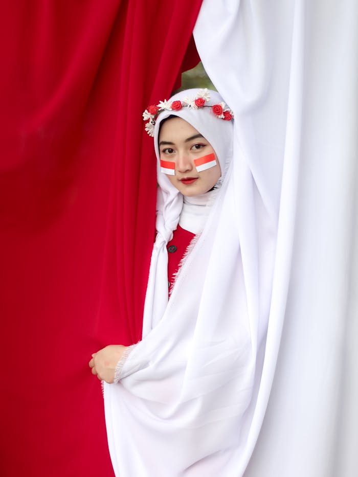 pexels photo 8458378 A young woman wearing traditional Indonesian clothing with face painted red and white, symbolizing the Indonesian flag.